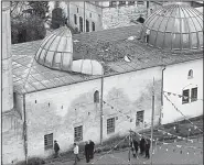  ?? AP/LEFTERIS PITARAKIS ?? This mosque in Kilis, Turkey, near the Syrian border, was damaged by two rockets fired Wednesday from Syria. It was the latest rocket attack in the border town since Turkey began its military offensive in Afrin, Syria.