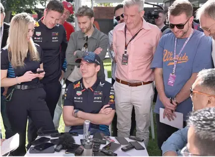  ?? ?? Red Bull’s Max Verstappen (centre) talks to the media at the Albert Park circuit.