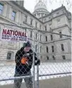  ?? AP CARLOS OSORIO/ ?? Dakota Pitz works on temporary fencing Friday at the state Capitol in Lansing, Michigan.