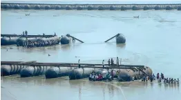  ?? — PTI ?? Workers construct a pontoon bridge over the Ganga for the upcoming Kumbh Mela in Allahabad on Tuesday.