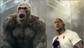  ?? Photos and text from wire services WARNER BROS. VIA AP ?? This image released by Warner Bros. shows Dwayne Johnson in a scene from “Rampage.” Johnson’s arcade game-inspired “Rampage” crept past last week’s top film “A Quiet Place” to take the No. 1 spot on the box office charts.