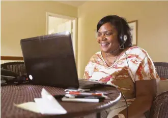  ?? Mark Mulligan / Houston Chronicle ?? Sitting in her home, Shelia Muldrow smiles as she sees her son Warren for the first time in over two weeks on a video chat screen last week. He began to sing her a song from his childhood.