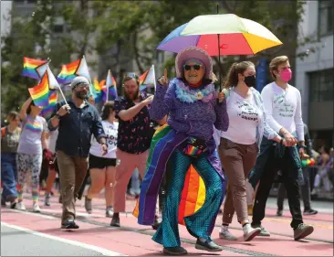  ?? PHOTOS BY ARIC CRABB — STAFF PHOTOGRAPH­ER ?? Marchers in the 52nd annual San Francisco Lesbian Gay Bisexual Transgende­r Pride Parade make their way down Market Street on Sunday. Thousands of people gathered to watch the first Pride Parade after two years of COVID cancellati­ons.