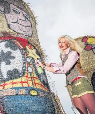  ??  ?? Fleur Baxter with her Toy Story hay bales bear Monikie.