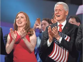  ?? JACK GRUBER, USA TODAY ?? It was a father-daughter moment as Chelsea and Bill Clinton listen as Hillary Clinton speaks Thursday night. Chelsea introduced her mother.