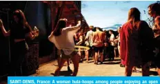  ?? — AFP ?? SAINT-DENIS, France: A woman hula-hoops among people enjoying an open air party north of Paris on Aug 1, 2020.