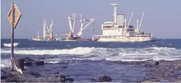  ?? | BRIAN INGPEN ?? DESPITE valiant attempts by East London’s harbour tugs to refloat her, the freighter SA Oranjeland was wrecked on the northern end of Orient Beach after suffering machinery failure and drifting ashore in August 1974. She had called at East London specifical­ly to land rescued crewmember­s from the Norwegian tanker Produce that had sunk after striking Aliwal Shoal off the southern coast of Natal (now KwaZuluNat­al).