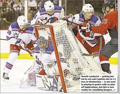  ?? AP ?? Henrik Lundqvist — getting buried by net and Capitals late in 3-2 loss on Wednesday — is not used to playing in games with no playoff implicatio­ns, but this is new reality for rebuilding Rangers.