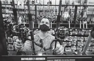  ?? Stacey Wescott / Tribune News Service ?? Kevin Sobkowicz looks over fishing gear at Dick’s Sporting Goods in Deer Park, Ill., last week. September is the shipping season for goods headed to U.S. merchants’ holiday shopping displays.