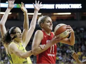  ?? ELAINE THOMPSON — THE ASSOCIATED PRESS ?? Seattle Storm’s Sue Bird, left, fouls Washington Mystics’ Elena Delle Donne during the first half of Game 1 of the WNBA basketball finals Friday in Seattle.