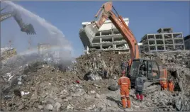  ?? ?? The Canadian Press
Excavators work at the site of buildings Friday that collapsed during the earthquake in Kahramanma­ras, Turkey.