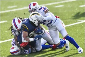  ?? ADRIAN KRAUS - THE ASSOCIATED PRESS ?? Los Angeles Chargers running back Austin Ekeler (30) is tackled on the run by Buffalo Bills strong safety Micah Hyde (23) during the first half of an NFL football game, Sunday, Nov. 29, 2020, in Orchard Park, N.Y.