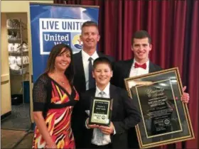  ?? CHAD FELTON — THE NEWS-HERALD ?? Scott Marn stands with his wife, Wendy, and sons, Jagger, center, and Dylan at LaMalfa Party Center in Mentor during United Way of Lake County’s Annual Meeting April 27. Marn, 2016 campaign chair and Mentor City Councilman, accepted two awards at the...