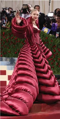  ?? ?? Gigi Hadid was more redefined cat woman than golden girl. She wore a tight-as-skin, blood red Latex catsuit with a corseted bodice and huge, quilted Versace coat.