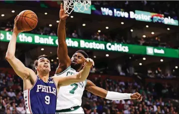  ?? MADDIE MEYER/GETTY IMAGES ?? The 76ers’ Dario Saric takes a shot against the Celtics’ Jaylen Brown during Game 5 of the Eastern Conference semifinals Wednesday at TD Garden in Boston.