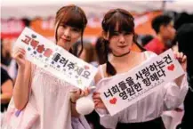  ??  ?? (left) Eager fans waiting for the concert to start. (right and below) Eight of the ninemember EXO easily charmed the audience with their music.