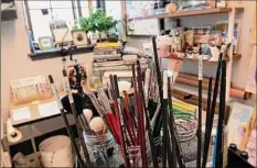  ?? ?? Paint brushes peek out of jars in the art studio of Lexi Hannah in the Albany Barn.