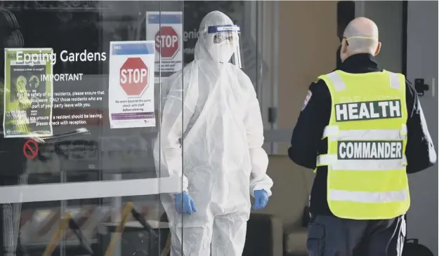  ?? PICTURE: AFP/GETTY ?? 0 Medical workers wait at the entrance of the Epping Gardens care facility in Melbourne as the city battles fresh outbreaks of Covid-19