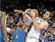  ?? [AP PHOTO] ?? Oklahoma City Thunder guard Russell Westbrook, left, and Sacramento Kings center Kosta Koufos battle for the ball during Tuesday’s game in Sacramento, California.