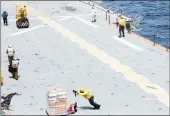  ?? PICTURE: BLOOMBERG
ALEX FLYNN ?? Sailors move aid supplies aboard the USS Kearsarge, stationed off the coast of San Juan, Puerto Rico, in October.