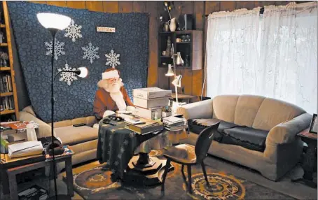  ?? STACEY WESCOTT/CHICAGO TRIBUNE PHOTOS ?? Dressed as Santa Claus, John Sullivan, 81, prepares to prerecord individual­ized video messages for children at his home Nov. 30 in Streamwood.