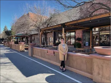  ?? ASHLEY BUSSART — COURTESY ?? City Manager Kathleen Salguero Trepa poses near an outdoor dining area in downtown Winters.