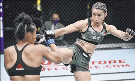  ?? Chris Unger Zuffa LLC ?? Tecia Torres puts a kick to the body of Brianna Van Buren in their women’s strawweigh­t bout during UFC on ESPN 11 on Saturday night at the UFC Apex facility. Torres scored a unanimousd­ecision upset victory.