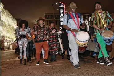  ?? ELIZABETH ROBERTSON/THE PHILADELPH­IA INQUIRER/TNS ?? Event promoter Mister Mann Frisby (second from left) organized a “Black Panther: Wakanda Forever” night Nov. 11 in Philadelph­ia to celebrate the opening of the new Marvel film.