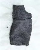  ??  ?? A fragment of a Herculaneu­m scroll carbonised during the eruption of Mount Vesuvius. Photograph: Andrew Brookes/Diamond Light Source Ltd