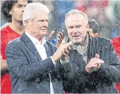  ?? AFP ?? Hoffenheim benefactor Dietmar Hopp, left, and Bayern Munich CEO Karl-Heinz Rummenigge applaud on the pitch after the suspension of the match.