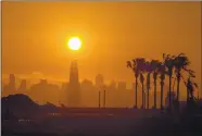  ?? RAY CHAVEZ — STAFF ARCHIVES ?? The sun sets behind the city of San Francisco seen from Alameda Point in September. According to NASA, 2020 was the hottest year ever recorded.