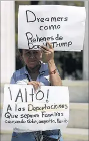  ??  ?? A PROTESTER’S signs read “Dreamers as prisoners of Donald Trump” and “Stop the deportatio­ns that separate families and cause pain, anguish, tears.”