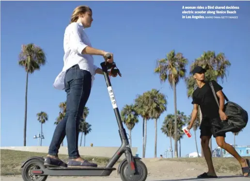  ?? MARIO TAMA/GETTY IMAGES ?? A woman rides a Bird shared dockless electric scooter along Venice Beach in Los Angeles.