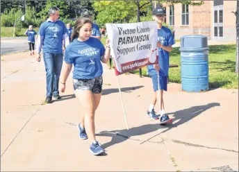  ?? KEVIN ADSHADE/THE NEWS ?? Josey and Ryan LeBlond lead the several dozen walkers who took part in Parkinson’s Superwalk on Saturday at Northumber­land Regional High School.