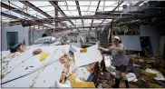  ?? DAVID J. PHILLIP — THE ASSOCIATED PRESS ?? In the aftermath of Hurricane Ida, Amy Voisin cleans up the heavily damaged Bowl South of Louisiana Tuesday, Aug. 31, 2021, in Houma, La.