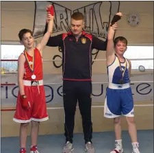  ??  ?? Eoin Pluck lifts the hands of Michael Cash of Rathnew and Philip Feokrytov of Arklow after their bout.