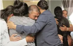  ?? | TRACEY ADAMS African News Agency (ANA) ?? RELATIVES and community members console each other after the gang-related killing of 7-year-old Imaan Solomons.