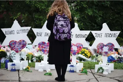  ?? BRENDAN SMIALOWSKI/AFP/GETTY IMAGES ?? Mourners hold an emotional vigil Sunday for victims of a mass shooting at a Pittsburgh synagogue. The attack, Andrew Cohen writes, was horrifying, depleting and wrenching — but not surprising.