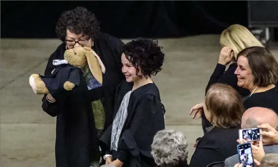  ?? Michael M. Santiago/Post-Gazette ?? U.S. Supreme Court Justice Sonia Sotomayor kisses a stuffed animal dressed in robes given to her by Harlie Donnelly of Franklin Park, center, who was dressed as the justice. Justice Sotomayor spoke on her life and career Friday at A.J. Palumbo Center at Duquesne University, Uptown.