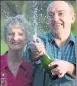  ??  ?? LUCKY: David and Carol Martin pop the champagne.