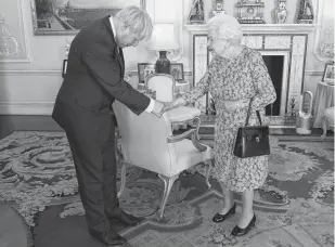  ?? VICTORIA JONES REUTERS ?? Queen Elizabeth II welcomes Boris Johnson during an audience in Buckingham Palace, where she will officially recognize him as the new prime minister. •