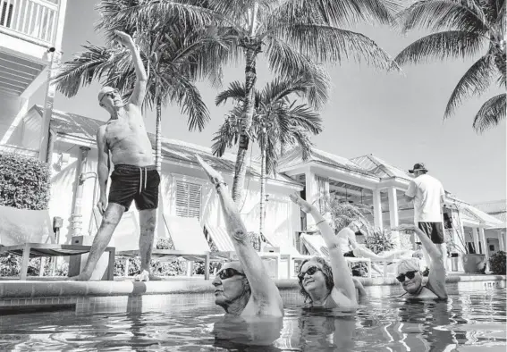  ?? MARK HEDDEN/THE NEW YORK TIMES ?? Peter Rogers teaches an aqua yoga class, put on hiatus during the coronaviru­s pandemic, Feb. 13 at the Marker Key West Harbor Resort in Key West, Florida.