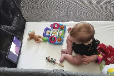  ?? COURTESY OF JULIE BUFKIN ?? Julie Bufkin’s 7-month-old boy, Calvin, interacts with his grandmothe­r Debbie Cameron, in Chandler, Ariz., on a FaceTime call from his crib in Tempe, Ariz.