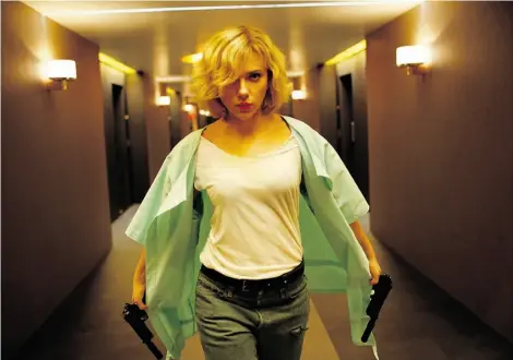  ?? J E SS I C A FO R D E / U N I V E R SA L ST U D I OS ?? Scarlett Johansson stars in Lucy, about a woman who unlocks the full power of her brain after a drug plot goes wrong.