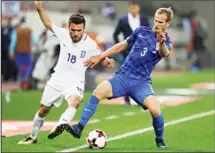  ?? (AP) ?? Greece’s Yannis Gianniotas (left), challenges for the ball with Croatia’s Ivan Strinic during the World Cup qualifying playoff second leg soccer match between Greece and Croatia at Georgios Karaiskaki­s Stadium, in
Piracus port, near Athens on Nov 12.