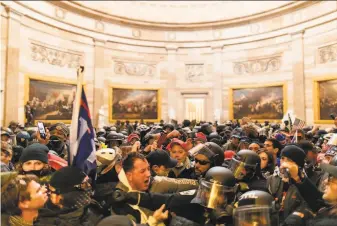  ?? Mostafa Bassim / Anadolu Agency ?? Backers of President Trump clash with police after breaching security and entering the Capitol in a protest that spiraled into a riot Wednesday. One officer died and a dozen were injured.