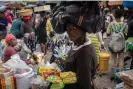  ?? Photograph: Johnson Sabin/EPA ?? A street vendor looks on at a market in Port-au-Prince last week amid concern about the increase in food insecurity in the country.