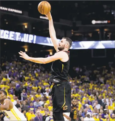  ?? Marcio Jose Sanchez / Associated Press ?? Cleveland’s Kevin Love, center, shoots against Golden State during Game 1 of the NBA Finals on Thursday.