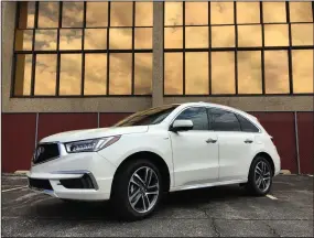  ?? ROBERT DUFFER/CHICAGO TRIBUNE ?? 2017 Acura MDX Sport Hybrid is the quietest, smoothest hybrid crossover on the market, and with three rows it can haul the family in style. Pictured in Mt. Prospect, Ill. on May 20.