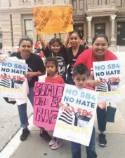  ?? Associated Press ?? LEFT: Rosario, right, and Marichuy, second from right in the back, demonstrat­e with family against a new Texas immigratio­n law on Monday in Austin. Opponents call Texas’ anti-sanctuary cities law a “show your papers” law since it empowers police to...